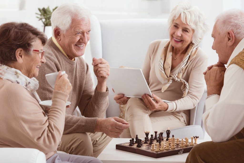 Elderly neighbors playing chess