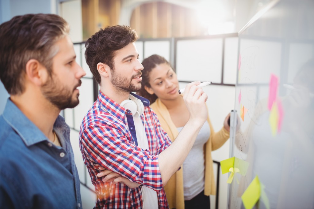 team writing on a whiteboard
