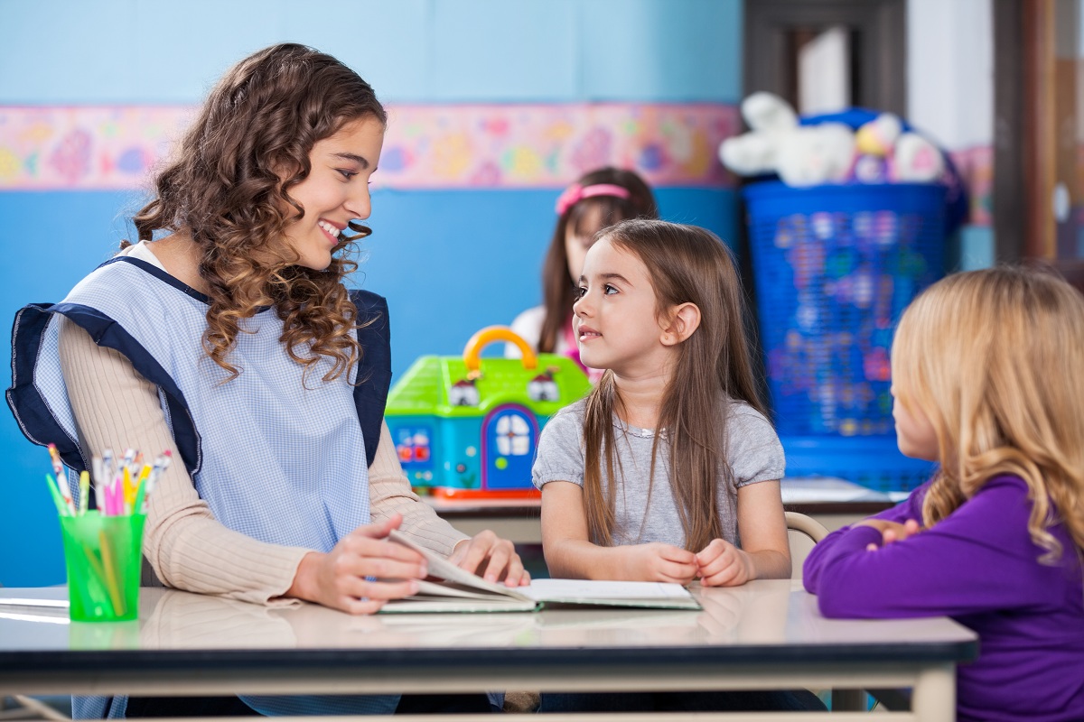 teacher and student reading a book