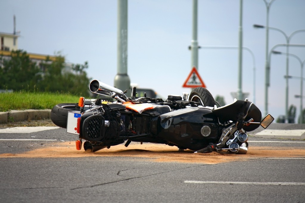 stumbled black motorcycle at the side of the road