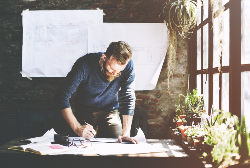 man jotting down his business idea