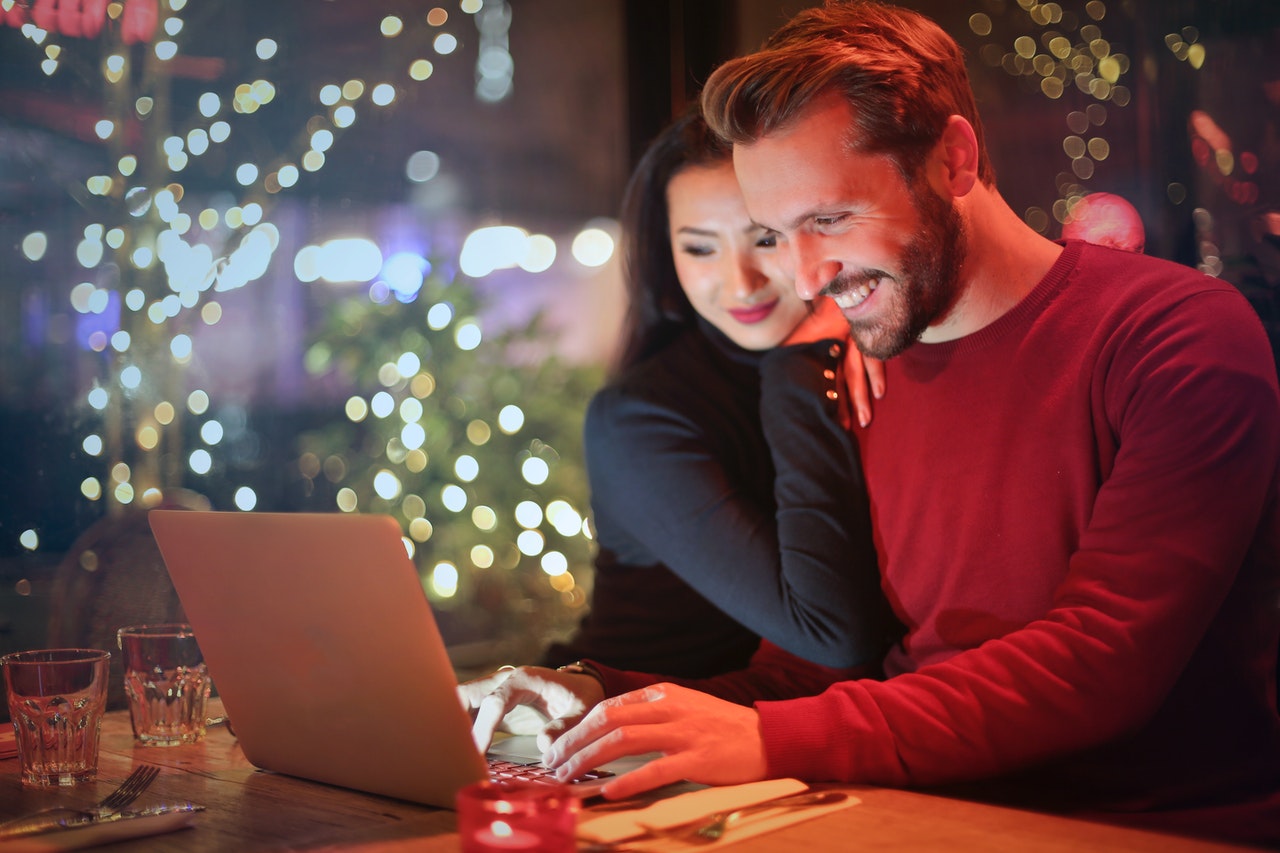 couple shopping online using laptop