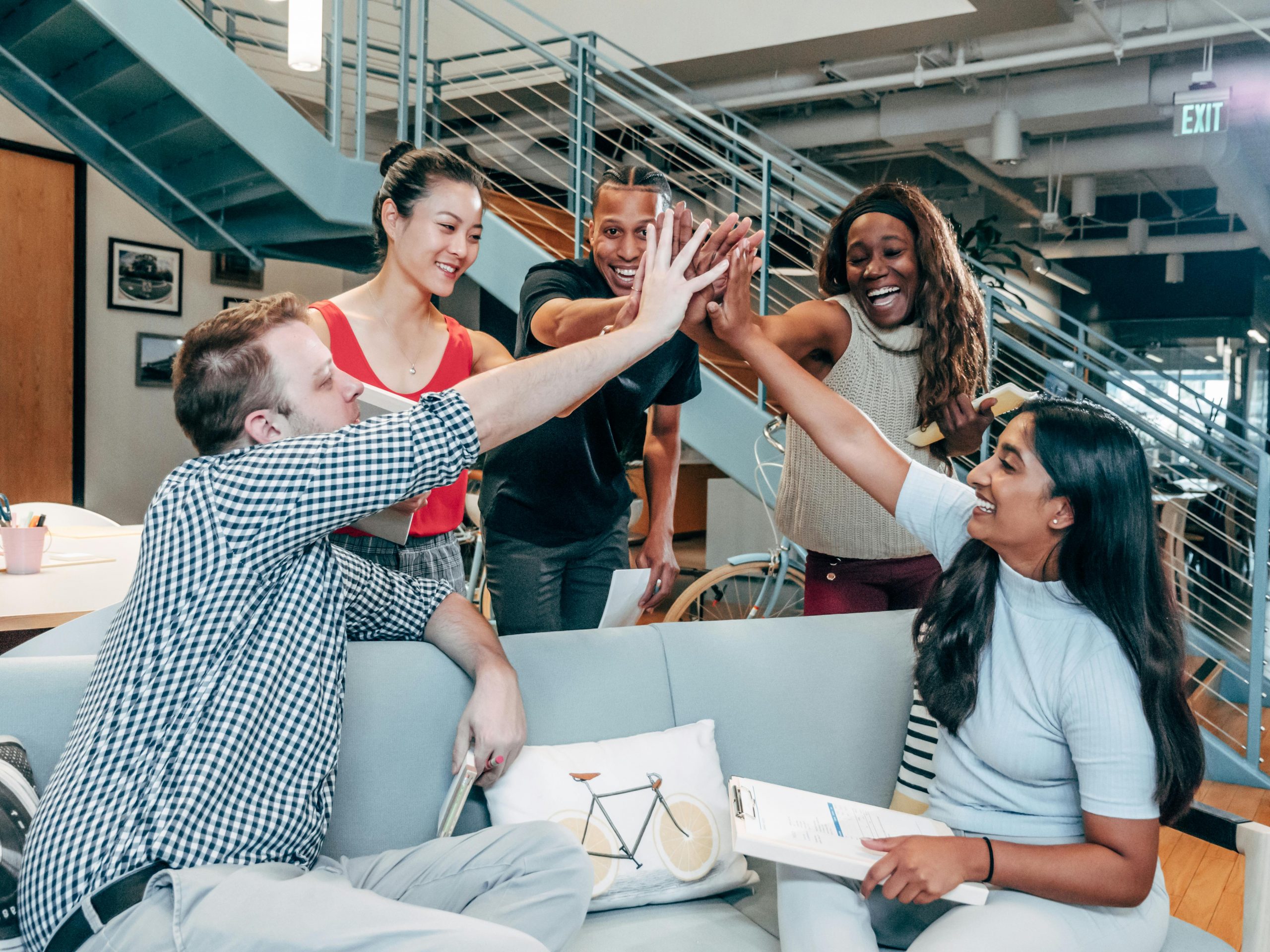smiling colleagues giving high-fives
